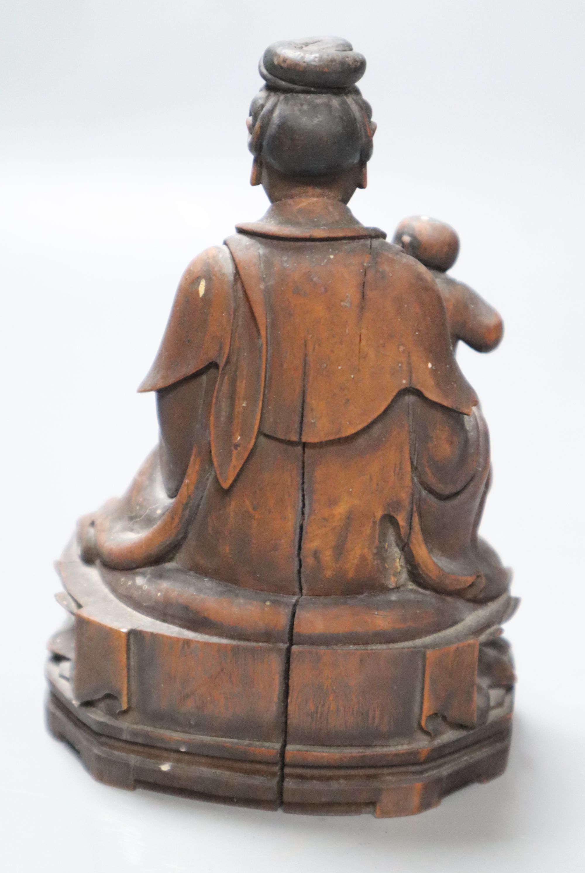 A 19th century Chinese wood group of Guanyin and a child, height 13cm